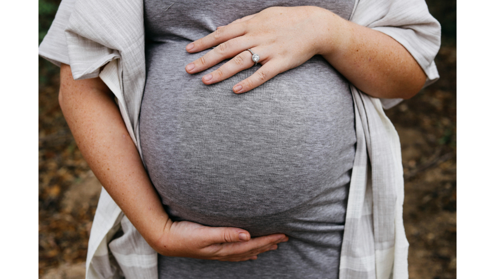 a pregnant woman showing her stomach
